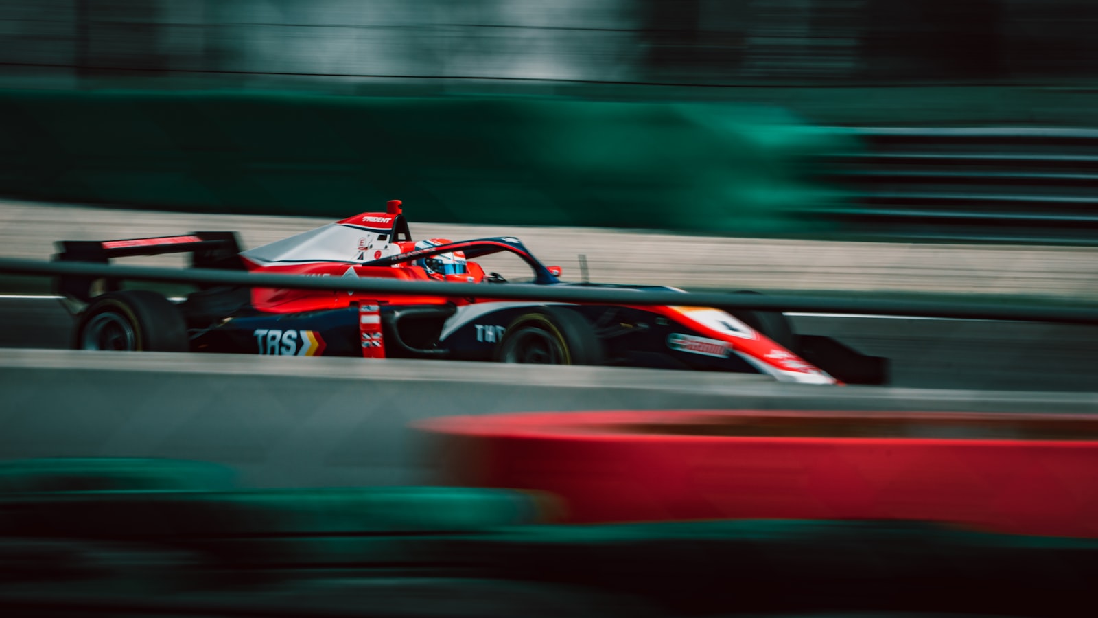 IndyCar driver behind the wheel on track — illustrating the extreme heat and hydration demands of motorsports racing.