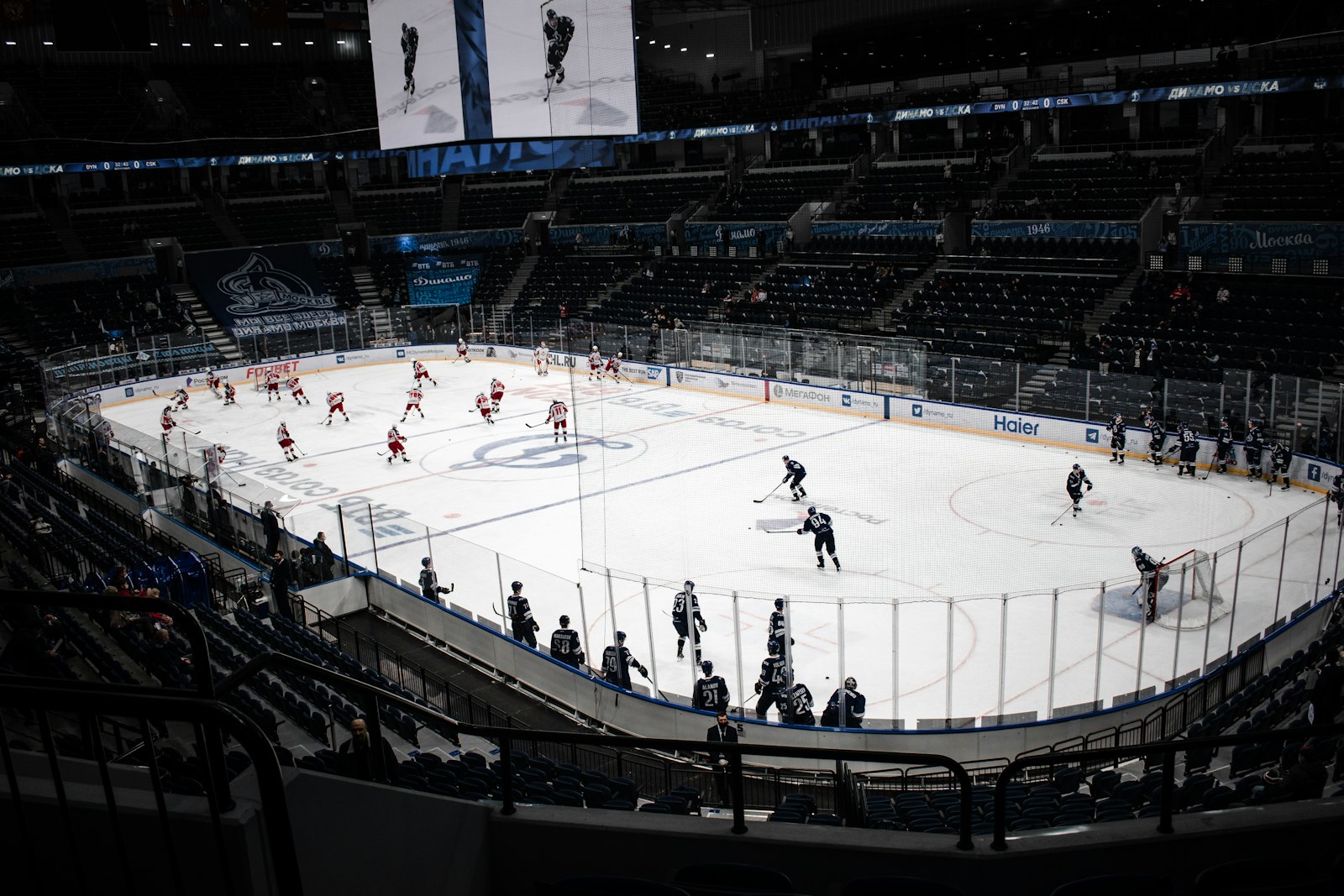 Wide view of an ice hockey arena during a game with players on the ice — illustrating the high sweat losses and hydration demands of Stanley Cup Playoffs hockey.
