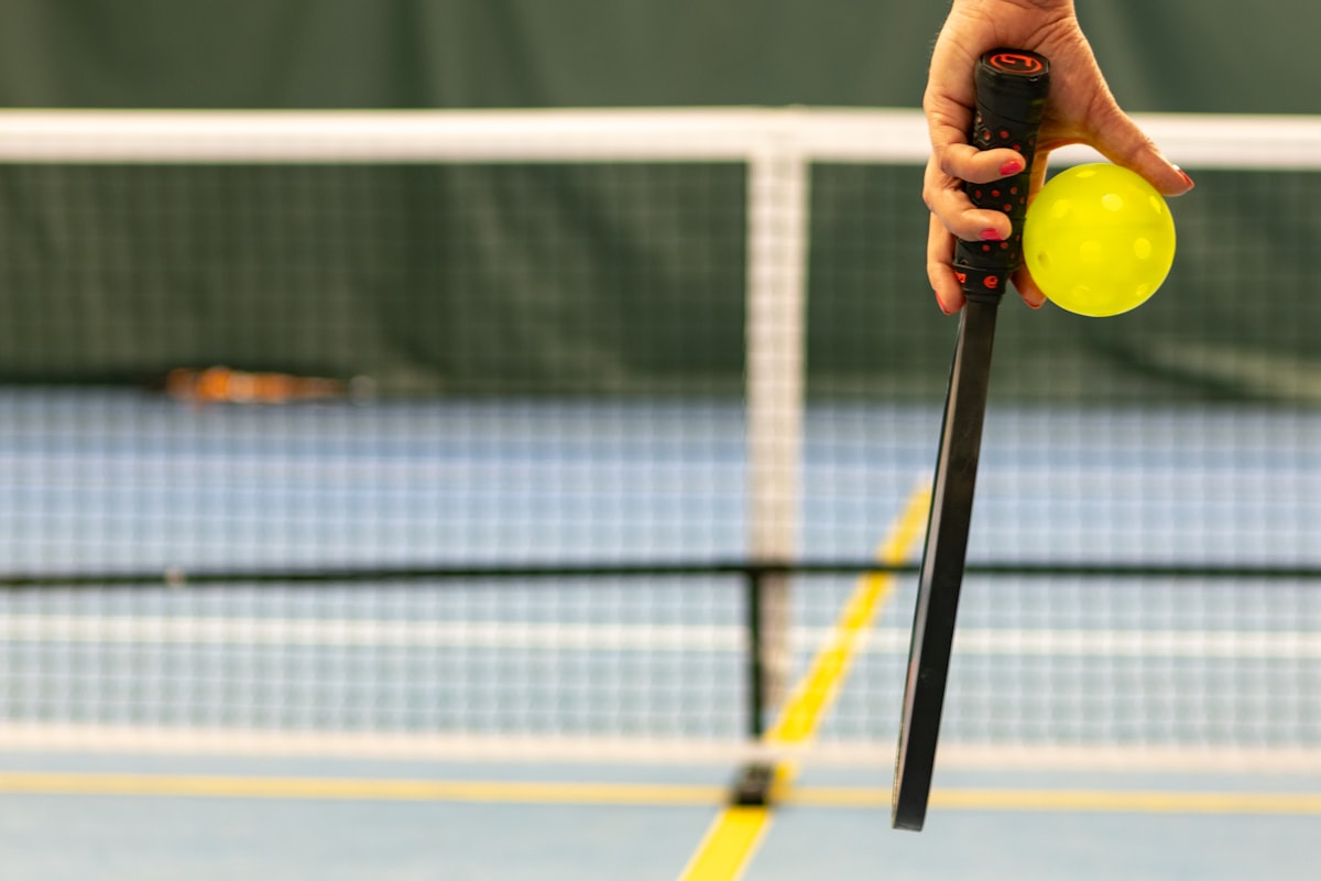 Pickleball players competing on an outdoor court in summer, when hydration and electrolytes matter most