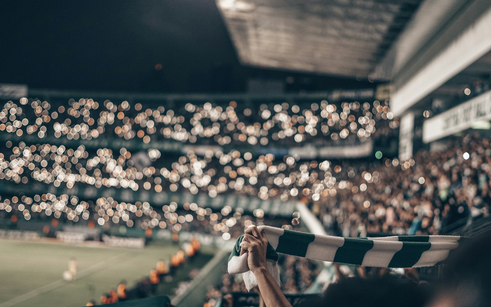 Packed soccer stadium in bright daylight with fans filling every tier — illustrating the heat and hydration demands World Cup spectators face this summer.