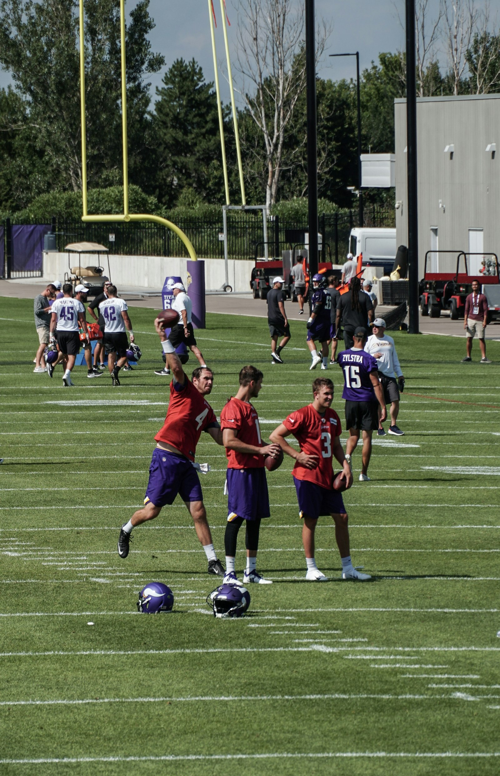 Football players running drills at preseason practice — illustrating the heat and hydration demands of August two-a-days.