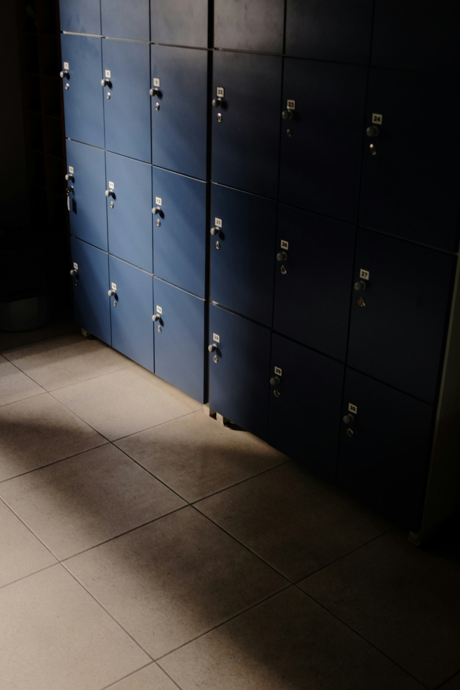 Athlete drinking water in a locker room while checking hydration status