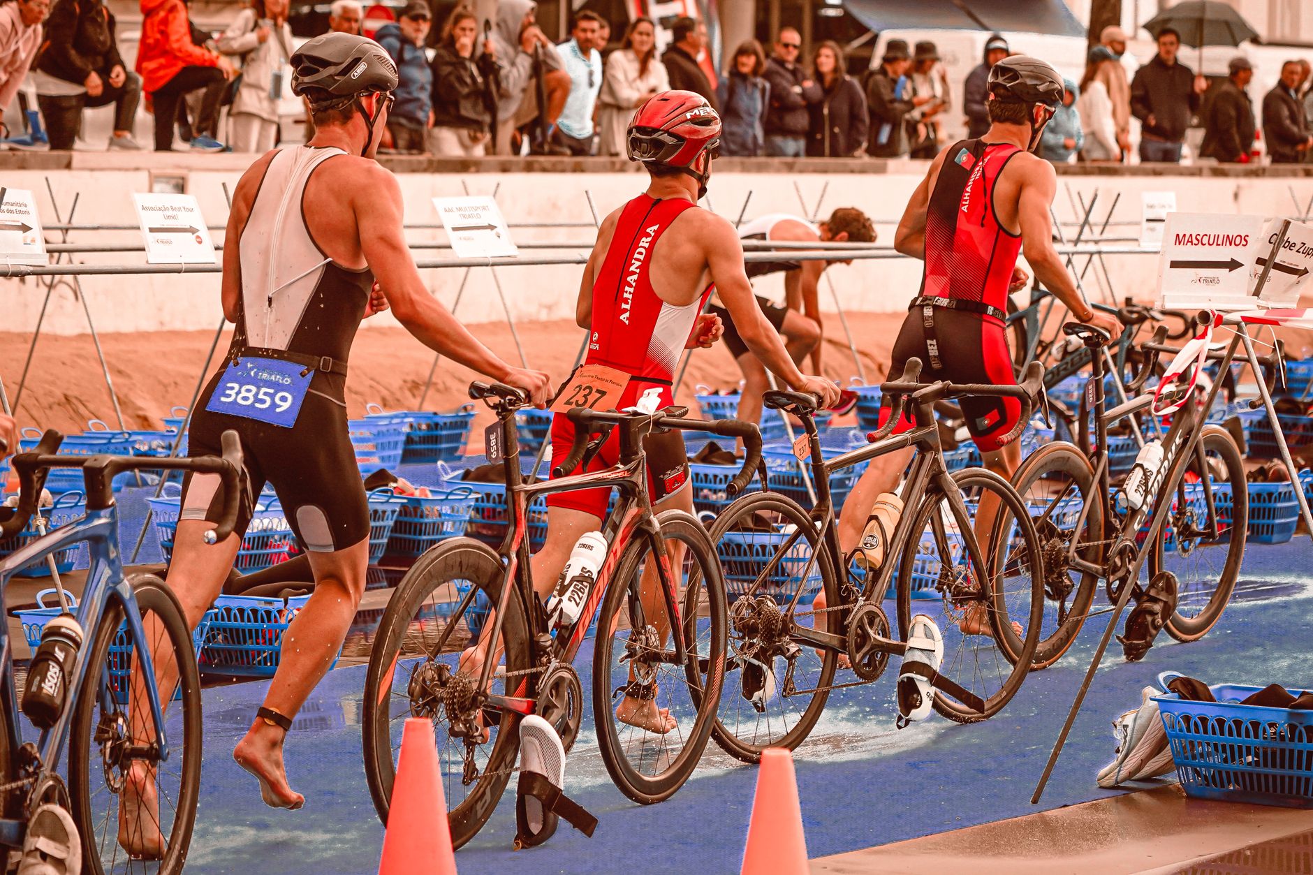 Athletes transition from swimming to cycling at a triathlon event.